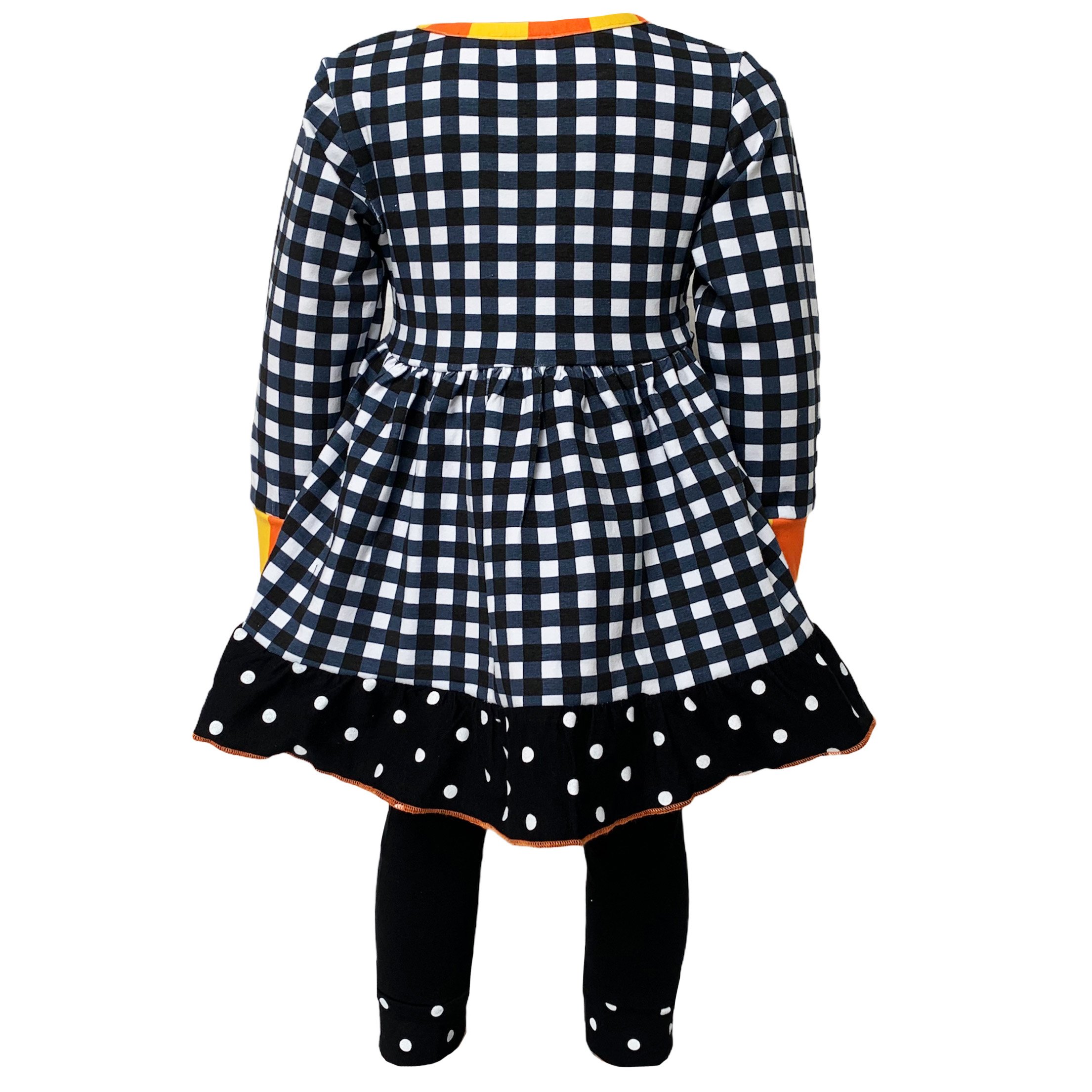 AnnLoren Girls Autumn outfit featuring a black and white gingham dress with polka dot ruffle trim and black leggings with ruffle trim.
